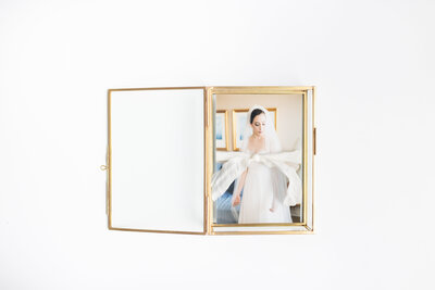 gold, glass box filled with wedding photography prints