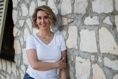Headshot of Sally Martinez in a white shirt smiling at camera