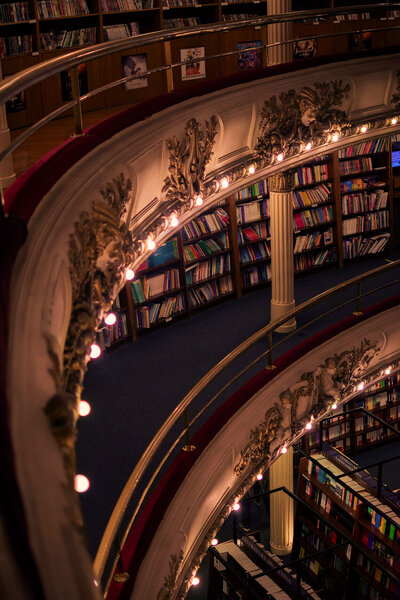 Image d'une bibliothèque avec des moulures et dans une ambiance tamisée, en rappel à la cible de Fenicia Studio le secteur culturel et à son identité visuelle qui nous plonge dans l'ambiance théâtrale de l'opéra.