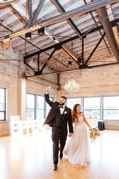 Newlyweds enjoying their reception with our luxury Michigan wedding packages.