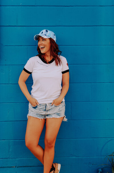 girl wearing hat smiling off camera