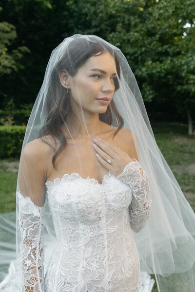 bride with veil covering in the courtyard