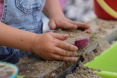 preschooler playing with sand