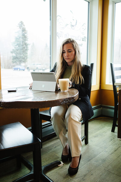 Southern Alberta Realtor Tamara working in a cozy coffee shop