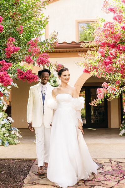 Couple walking through wedding venue elegant wedding dress