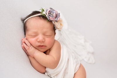 baby sidelaying with flower headband