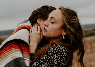 couple wrapped in blanket embracing