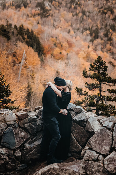 Couple in black clothing having an intimate moment in the white mountains in the fall by Lisa Smith Photography