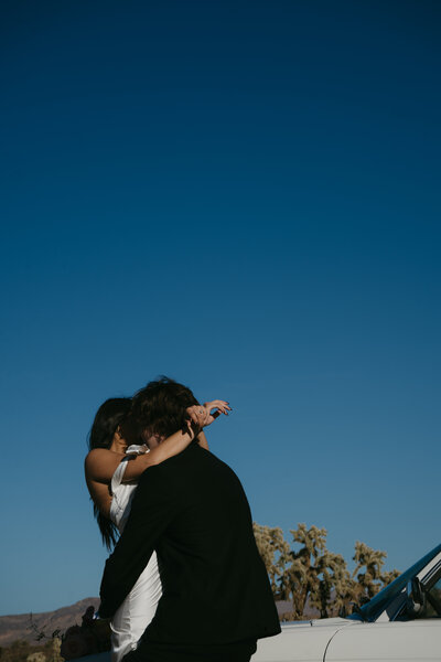 happy bride and groom hugging in the desert, elopement couple