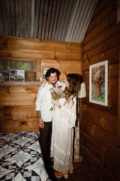 newyweds hugging in their cabin after their elopement