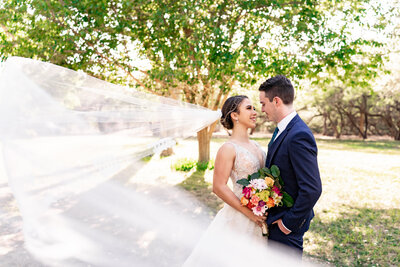 Outdoor wedding ceremony with arch couple kissing at ceremony