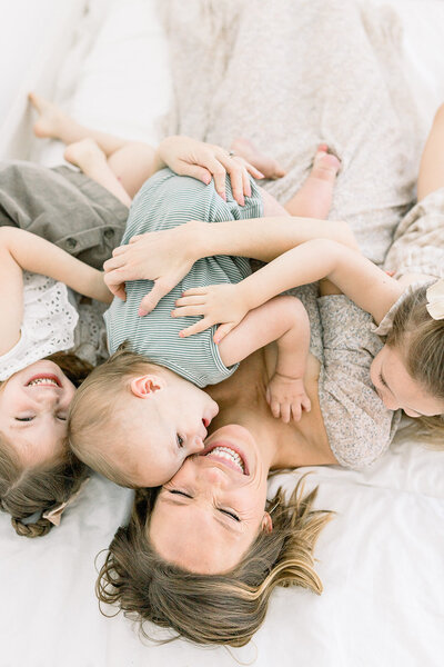 Family touching expecting mother's belly