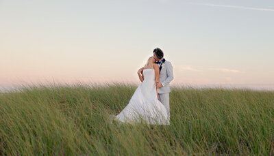 Bride and Groom kissing in the fields of Vanderhoop Homestead