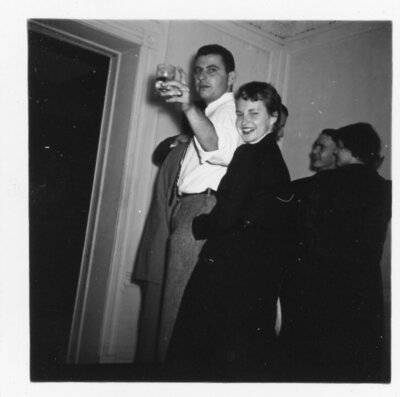 Vintage photo of couple at party looking back at camera