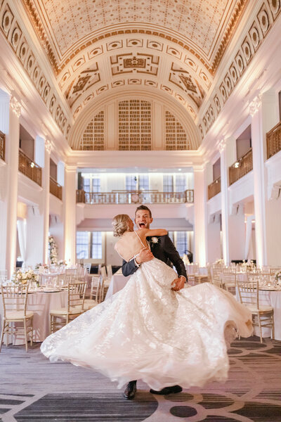 Bride and groom twirling at their wedding reception