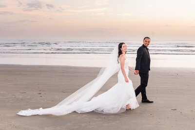 bride and groom walking on coronado beach san diego