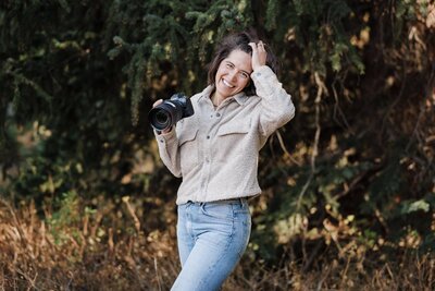 Wedding and Elopement Photography, micro wedding photographer poses with her camera in Rocky Mountains.