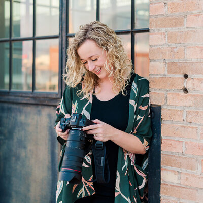Sara Vaz looking down at her camera during a branding session in Ogden, Utah.