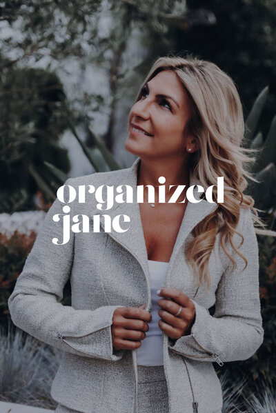 Jane Stoller smiling outdoors while adjusting her light-colored jacket, with the 'organized jane' logo overlaid on the image.