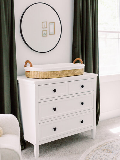 A newborn nursery dresser, changing basket, mirror, and curtains by Katie Stansfield Photography, a Richmond photographer.