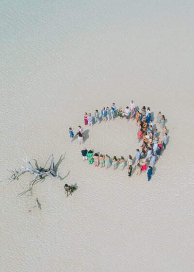 Guests gathered in a circle on Harbour Island for a barefoot day event.