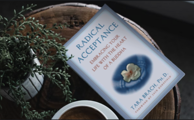 Radical acceptance book on a wood end table