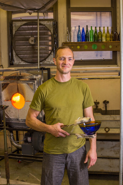 Business owner holding his product, blown glass bowl
