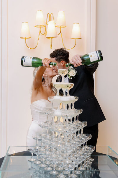 bride and groom kissing by champagne tower at Hall on Dragon in Dallas by Kortney Boyett Photography, Dallas wedding photographer
