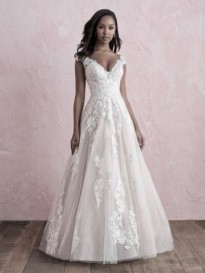 Subtle swiss dotted tulle creates a beautiful texture against soft sheet lace in this strappy ballgown.