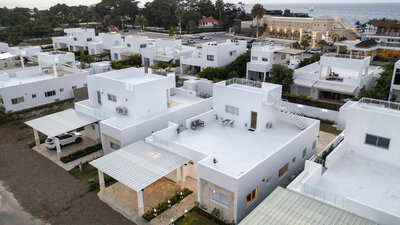 Aerial view of white modern villas presented as curated property selections by Nova Lux DR Properties