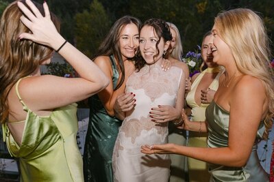 Guests hugging and celebrating during a wedding welcome party in Colorado