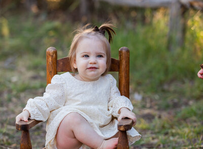 sitter girl in wooden chair