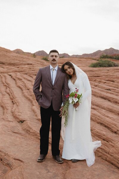 bride and groom pose at the petrified sand dunes in snow canyon state park