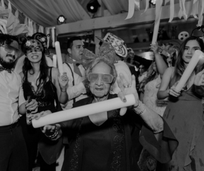 High-energy hora loca wedding moment with foam glow sticks and interactive crowd engagement