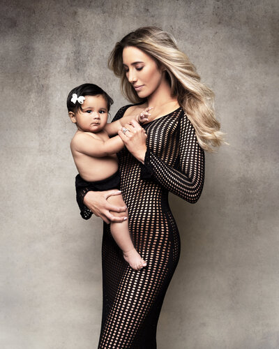 Mother and baby photo in classic and elegant studio setup, capturing the intimate and empowering side of motherhood.
