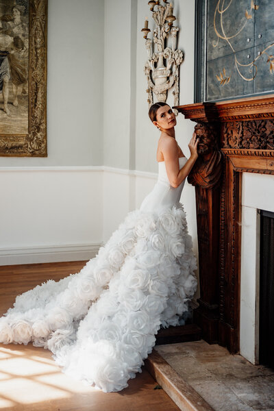 bride standing next to fireplace mantel