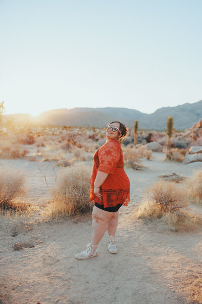 woman holding a camera and standing