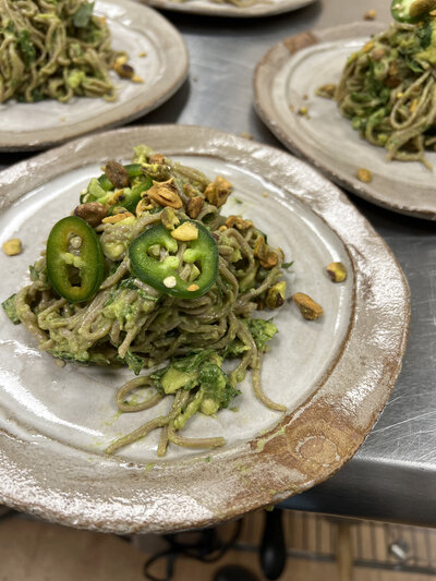 Gourmet veggie salad plated on a beautiful hand thrown ceramic plate