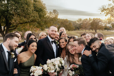 bride and groom surrounded by friends