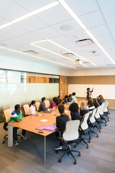 Women engaged in group coaching session, discussing career growth strategies and support for advancing in their careers.