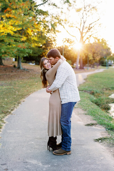 Couple embraces after proposal in Avondale Park