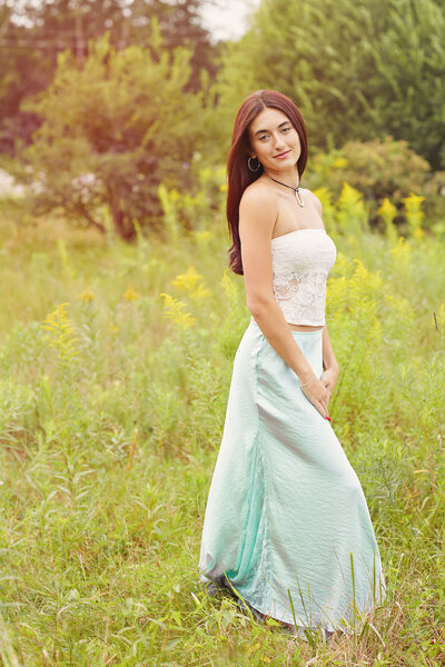 Senior girl in dress in a field