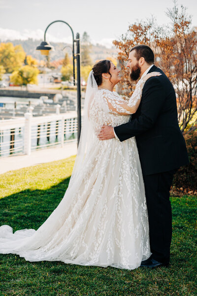 Bride and groom embracing during first look at Kwataqnuk Resort in Polson, MT