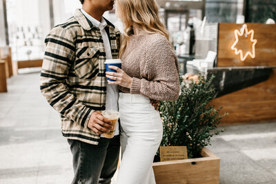 couple holding coffee cups