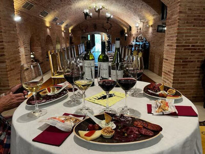 Table set up inside the winery with wine bottles, wine glasses and lunch for Wine Guide Madrid's Winery Lunch Experience.