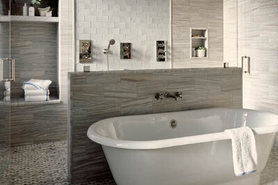 A newly designed primary bathroom with classic details in a traditional brownstone renovation by a Boston interior designer, blending old and new.