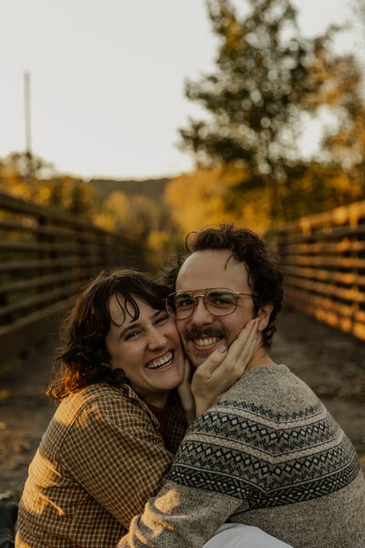Minnesota Engagement Photography of a couple sitting and being cozy together 