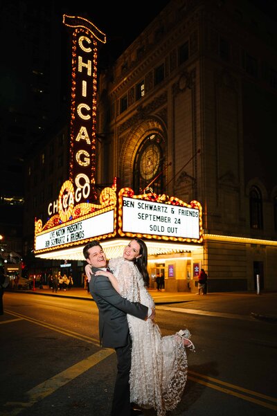 Happy bride and groom with the Chicago theater in the background.