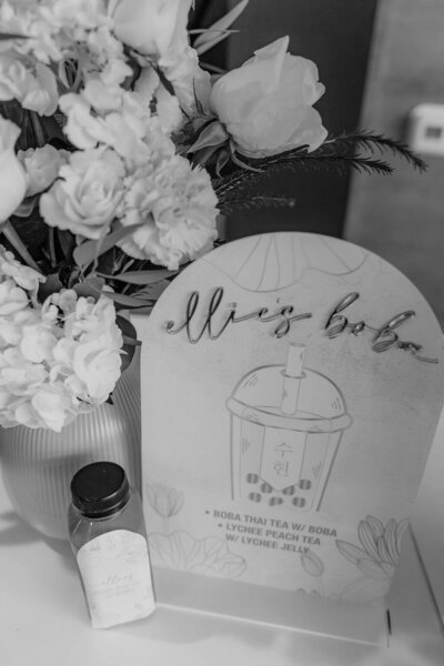 Black and white image of boba drink signage for doljabi planned by Fancy Chancey in San Diego CA