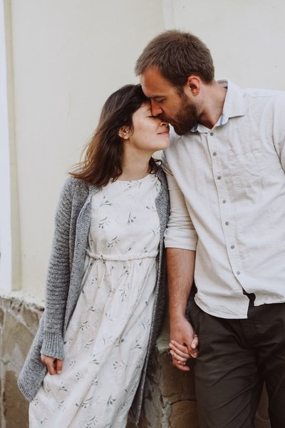 A couple hold hands as they kiss. A couples therapist in Florida can provide support. Learn more from a Florida therapist today.